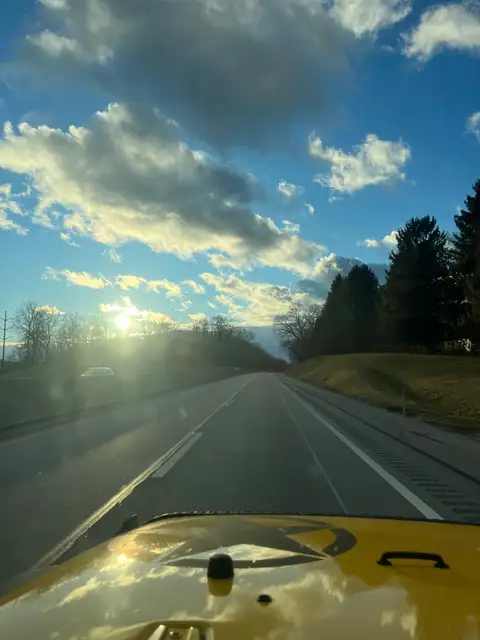 The open road meets a golden hour sky.